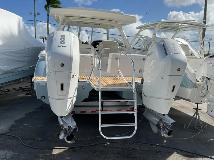 Pcm 51799 400dcis Yacht Photos Pics 2025 World Cat 400 DC-IS boat with twin outboard engines, docked under a sunny sky.