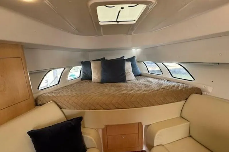 Saga Yacht Photos Pics Interior cabin of 2019 Intrepid 430 Sport Yacht with cozy bed and seating area.