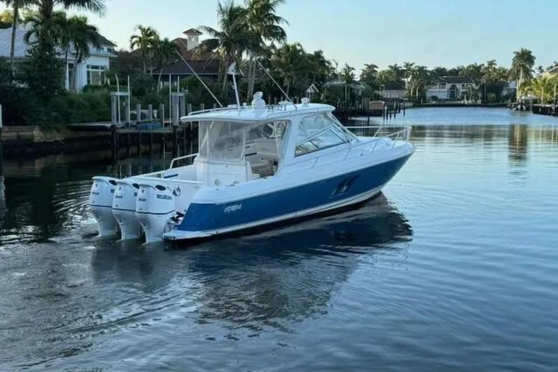 Saga Yacht Photos Pics 2019 Intrepid 430 Sport Yacht cruising on a calm, scenic waterway.