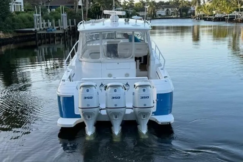 Saga Yacht Photos Pics 2019 Intrepid 430 Sport Yacht with triple 350 horsepower engines on a calm waterway.