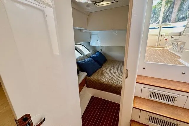 Saga Yacht Photos Pics 2019 Intrepid 430 Sport Yacht cabin with cozy bed and wooden steps.