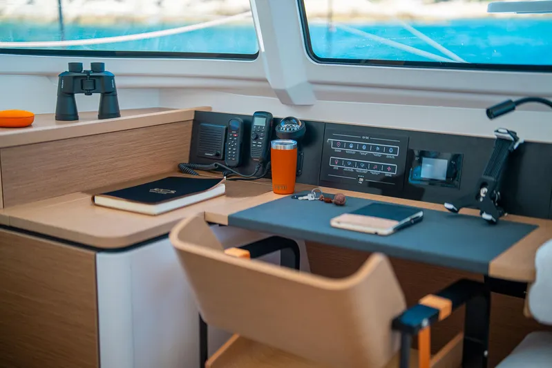  Yacht Photos Pics Modern yacht interior with navigation equipment, binoculars, and a notebook on a wooden desk. Excess 13, 2026.