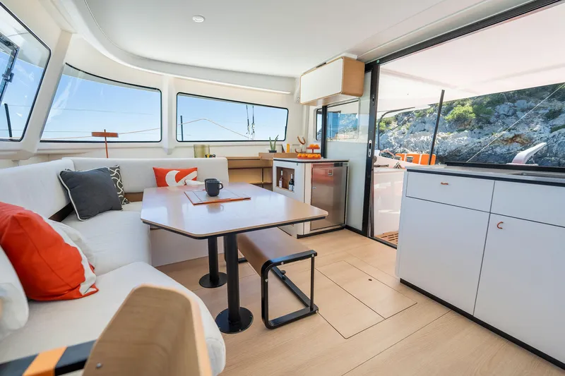  Yacht Photos Pics Modern interior of 2026 Excess 13 yacht with stylish seating and kitchen area.