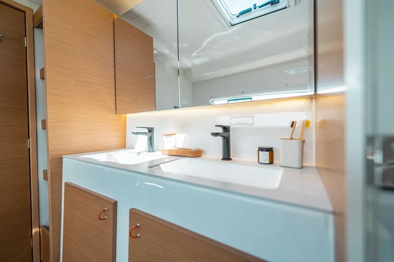  Yacht Photos Pics Modern bathroom interior in 2026 Excess 13 yacht, featuring sleek fixtures and wooden cabinetry.