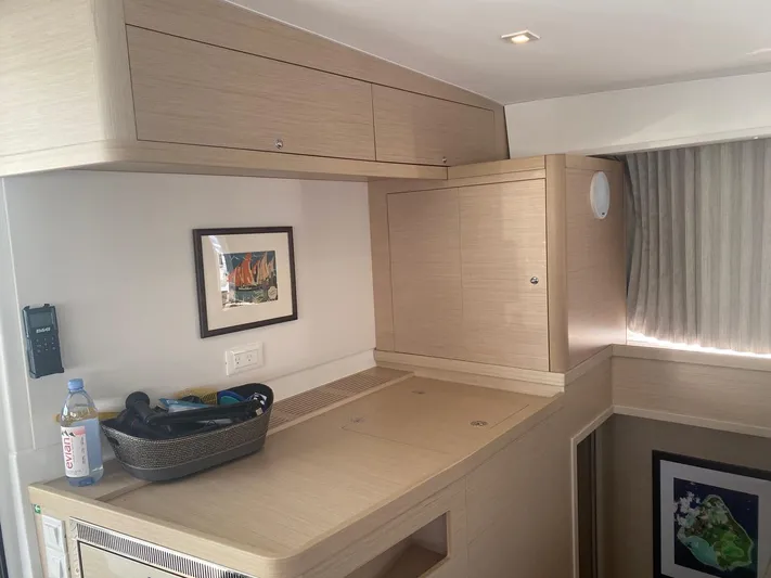 Alegria Yacht Photos Pics Interior of 2020 Lagoon 42 yacht with light wood cabinetry and framed artwork.