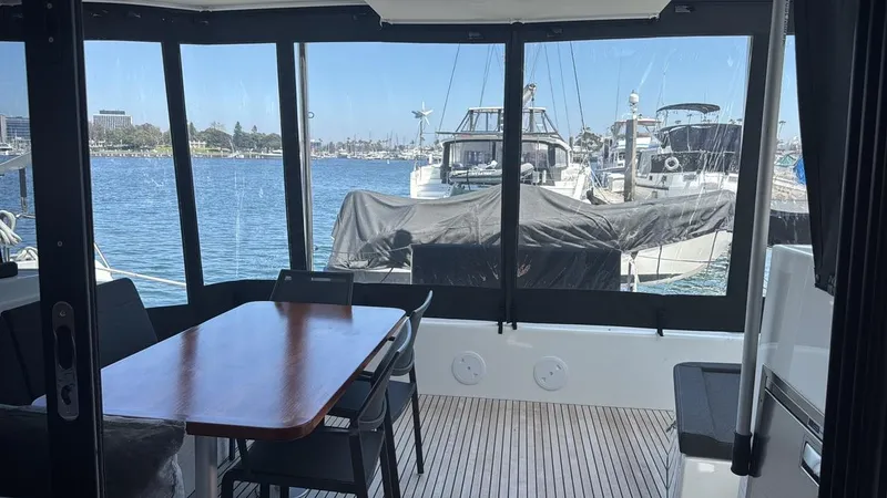 Alegria Yacht Photos Pics Interior view of 2020 Lagoon 42 catamaran with dining area overlooking marina.