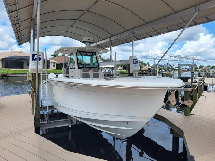  Yacht Photos Pics 2023 Caymas 341 CC boat docked under canopy on a sunny day.
