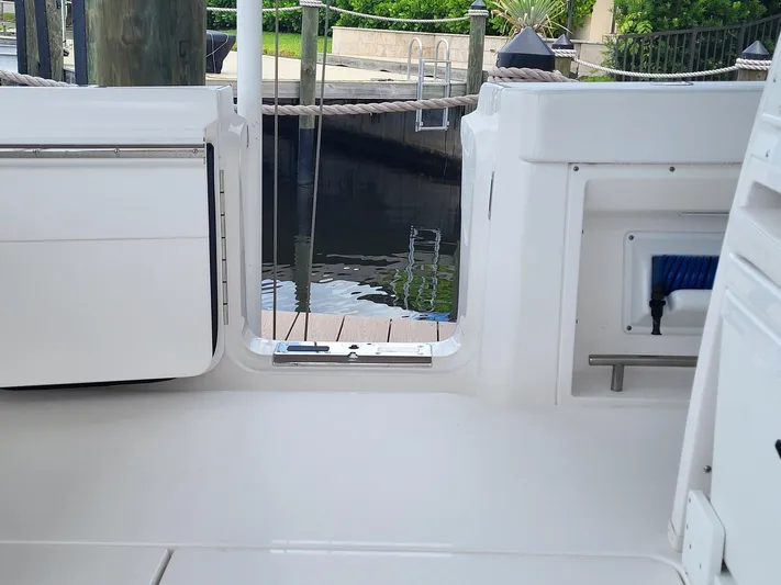  Yacht Photos Pics 2023 Caymas 341 CC boat interior, featuring sleek white design and dockside view.