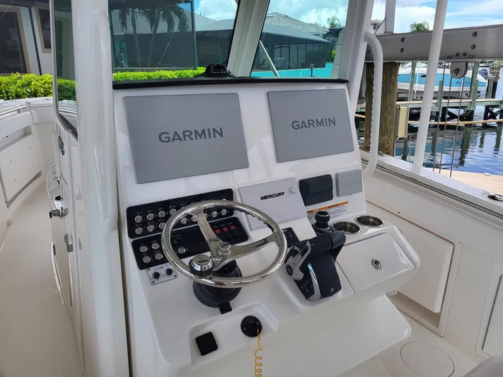  Yacht Photos Pics 2023 Caymas 341 CC boat dashboard with dual Garmin displays and Mercury controls.
