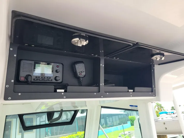  Yacht Photos Pics 2023 Caymas 341 CC boat interior with radio and storage compartments.