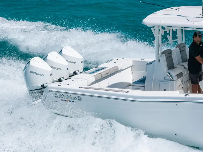  Yacht Photos Pics 2023 Caymas 341 CC boat cruising with powerful Mercury engines in clear blue waters.