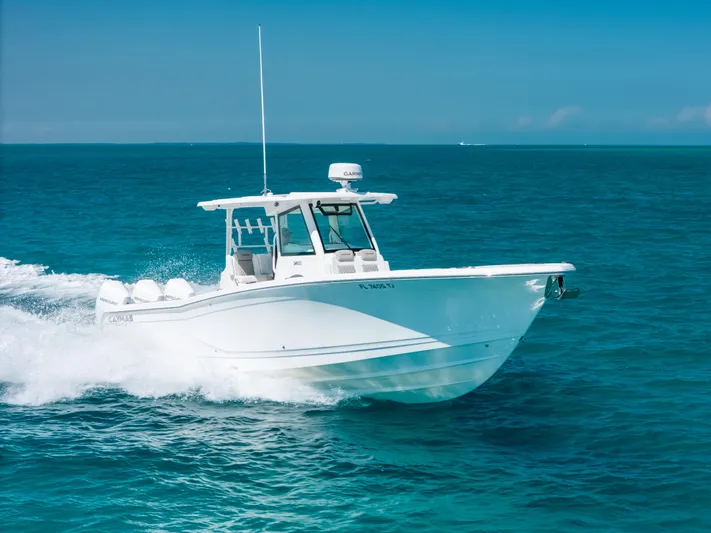  Yacht Photos Pics 2023 Caymas 341 CC boat cruising on clear blue ocean waters.