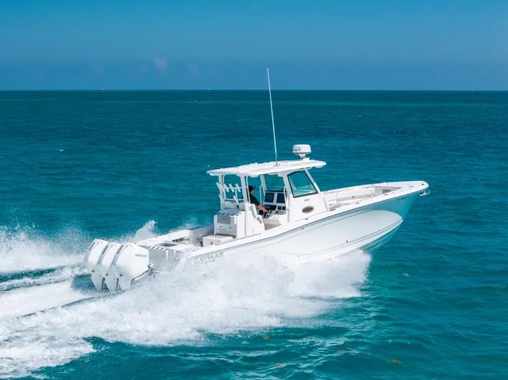  Yacht Photos Pics 2023 Caymas 341 CC boat cruising on clear blue ocean waters.