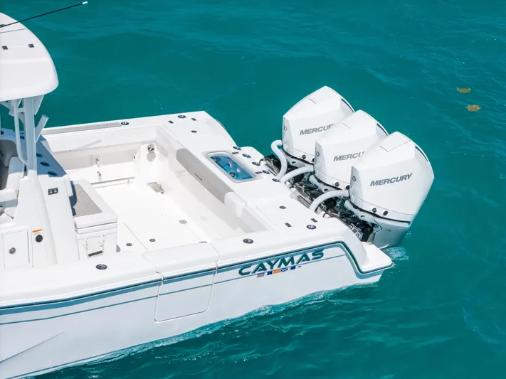 Yacht Photos Pics 2023 Caymas 341 CC boat with triple Mercury engines on turquoise water.