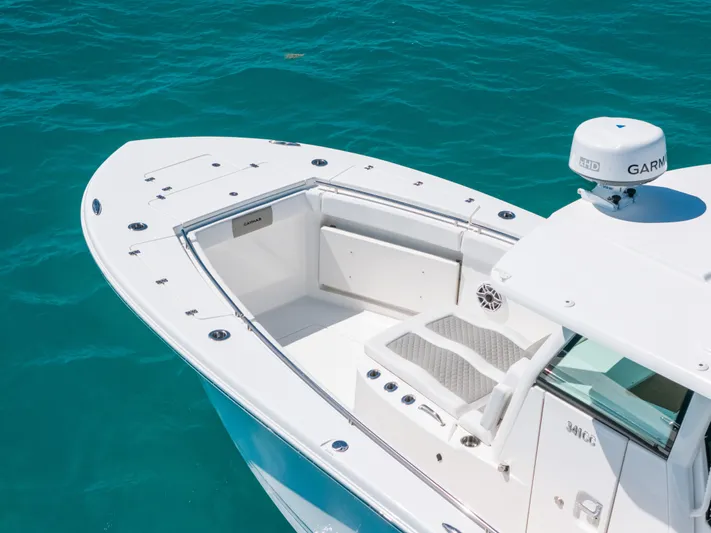  Yacht Photos Pics 2023 Caymas 341 CC boat on turquoise water, featuring a sleek white deck design.