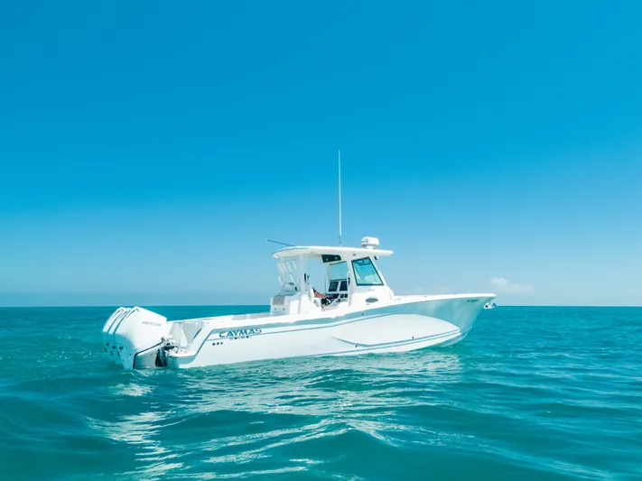  Yacht Photos Pics 2023 Caymas 341 CC boat on open sea under clear blue sky.