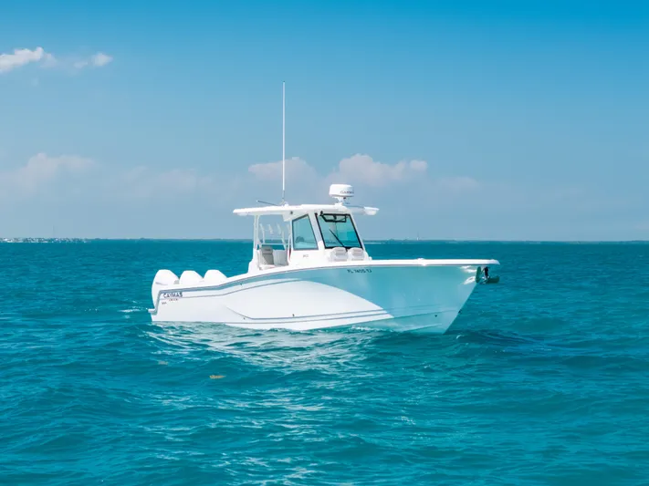  Yacht Photos Pics 2023 Caymas 341 CC boat on clear blue ocean water under a sunny sky.