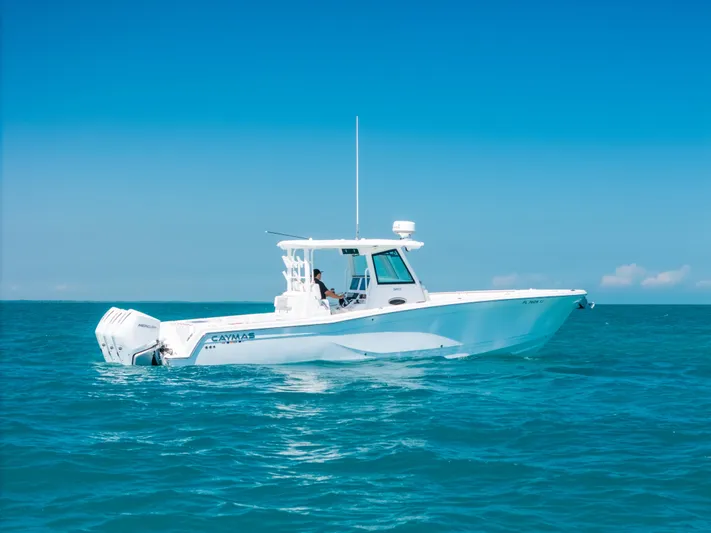  Yacht Photos Pics 2023 Caymas 341 CC boat cruising on clear blue ocean waters.