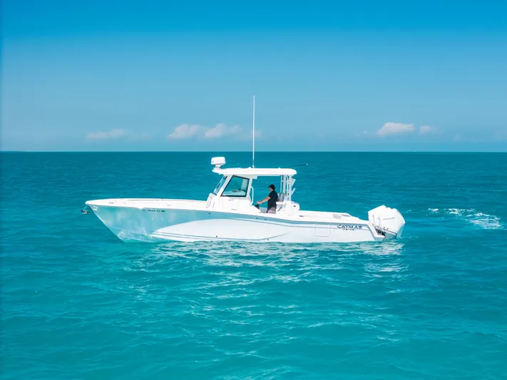  Yacht Photos Pics 2023 Caymas 341 CC boat cruising on clear blue ocean waters.