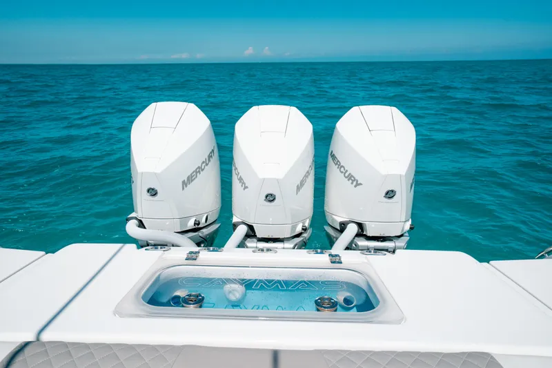  Yacht Photos Pics 2023 Caymas 341 CC boat with triple Mercury engines on open sea.