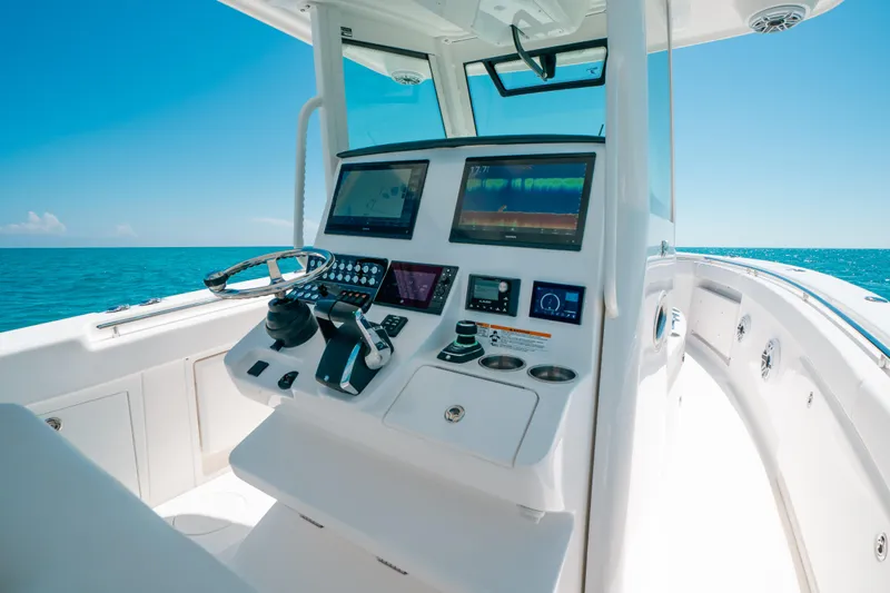  Yacht Photos Pics 2023 Caymas 341 CC boat dashboard with modern controls and ocean view.