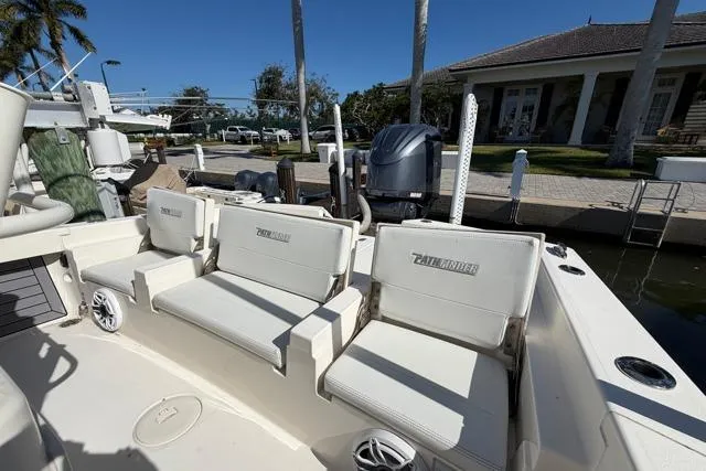  Yacht Photos Pics 2023 Pathfinder 2600 TRS boat with cushioned seating at a marina.
