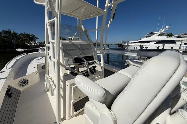  Yacht Photos Pics 2023 Pathfinder 2600 TRS boat interior with Garmin navigation, docked by luxury yachts.