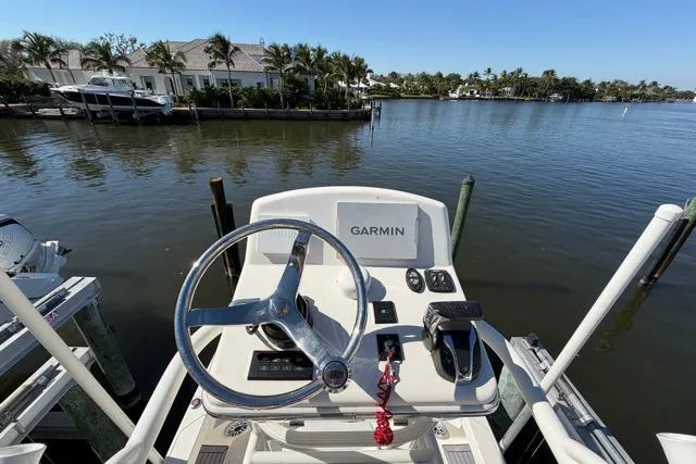  Yacht Photos Pics 2023 Pathfinder 2600 TRS boat helm with Garmin system, docked by waterfront homes.