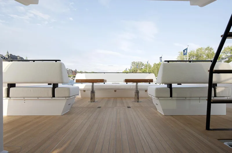  Yacht Photos Pics Luxurious Delta Powerboats 72 yacht deck with seating, wooden flooring, and scenic water view, 2026 model.