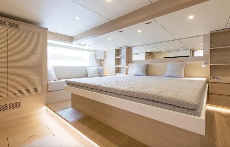  Yacht Photos Pics Luxurious bedroom interior of 2026 Delta Powerboats 72, featuring modern design and elegant lighting.