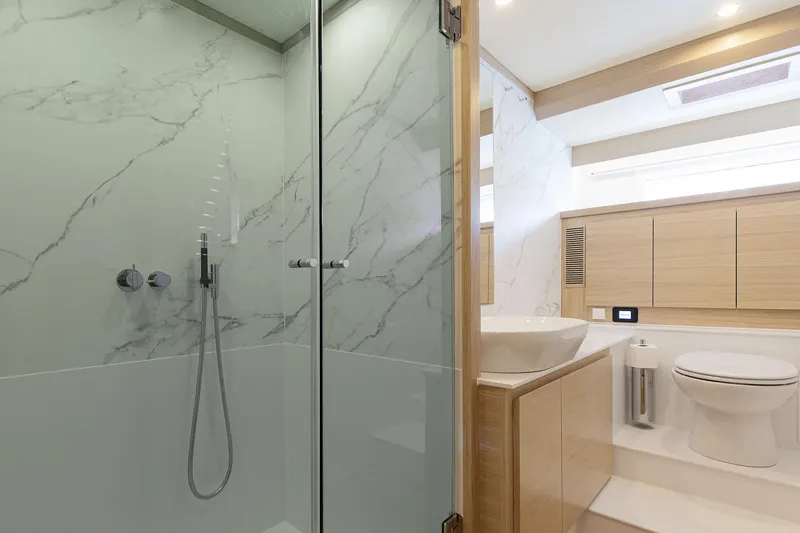  Yacht Photos Pics Luxurious bathroom in 2026 Delta Powerboats 72, featuring modern shower and elegant fixtures.