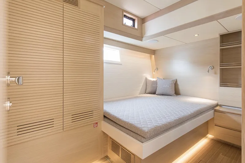 Yacht Photos Pics Luxurious cabin interior of 2026 Delta Powerboats 72, featuring a cozy bed and modern design.