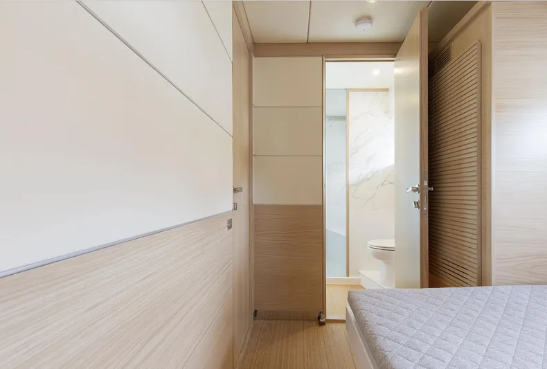  Yacht Photos Pics Luxurious interior of 2026 Delta Powerboats 72, featuring modern bedroom and bathroom design.