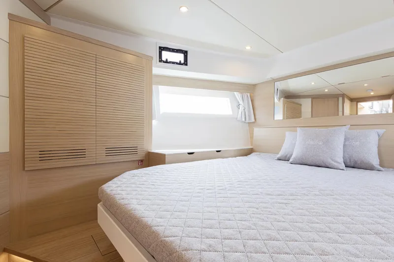  Yacht Photos Pics Luxurious cabin interior of 2026 Delta Powerboats 72, featuring a spacious bed and modern design.