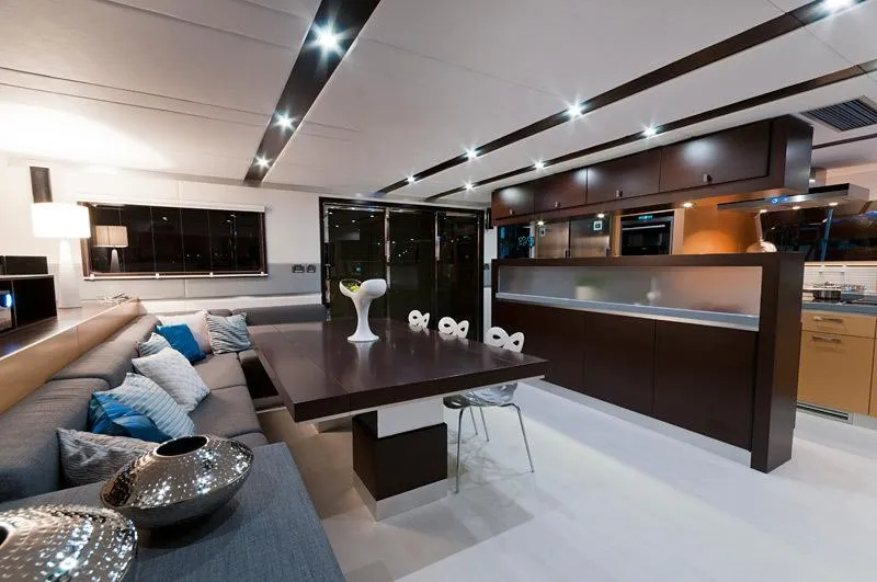 Mulan Yacht Photos Pics Luxurious interior of 2012 Sunreef 70 Sailing yacht with modern dining area and sleek design.