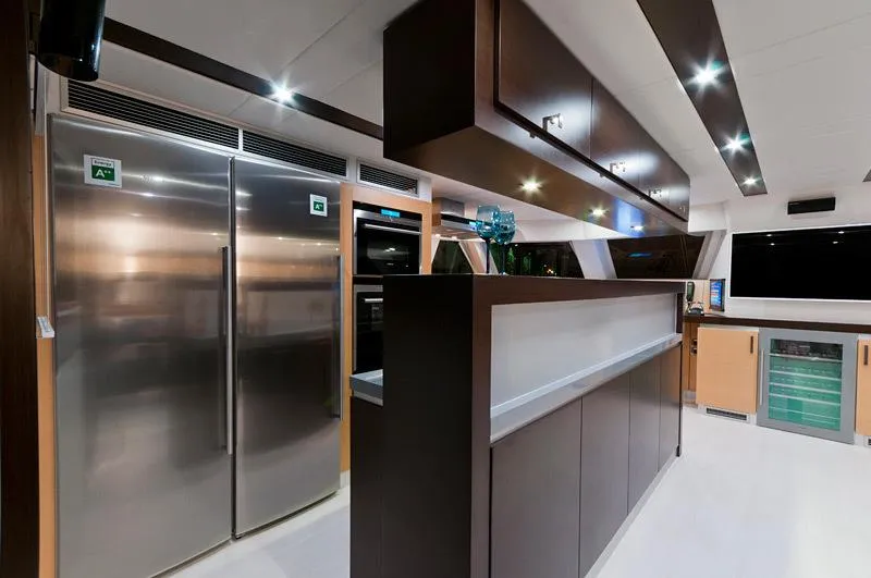 Mulan Yacht Photos Pics Luxurious kitchen interior of 2012 Sunreef 70 Sailing yacht with modern appliances and sleek design.
