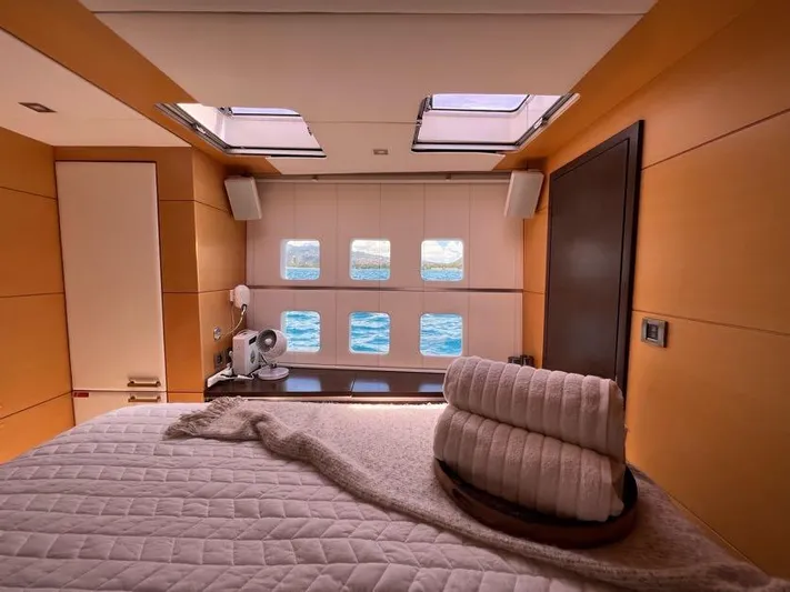 Mulan Yacht Photos Pics Luxurious Sunreef 70 Sailing yacht interior with ocean view, featuring cozy bed and modern decor.