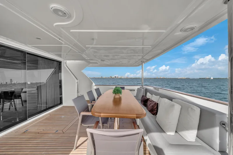 D'vinci Yacht Photos Pics Luxurious 2015 Custom Line Navetta 28 yacht deck with dining area and ocean view.