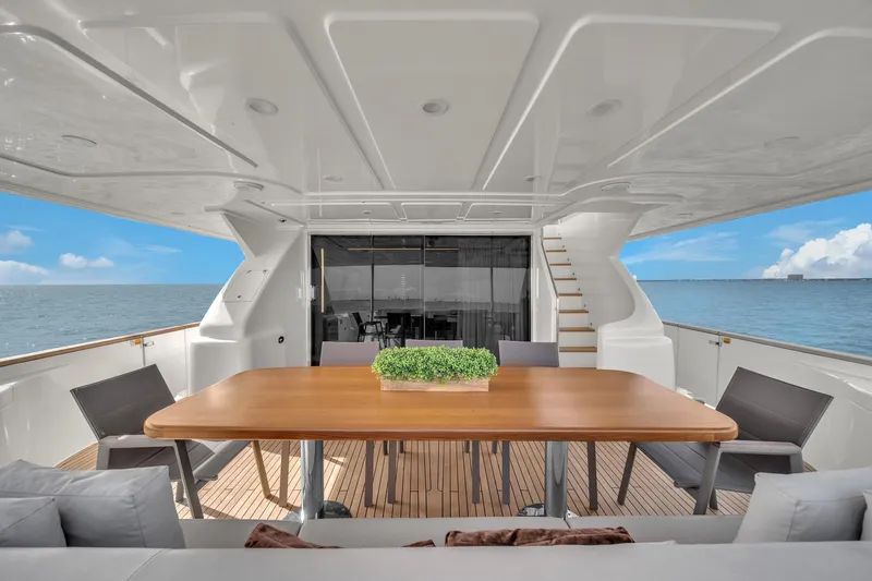 D'vinci Yacht Photos Pics Luxurious 2015 Custom Line Navetta 28 yacht deck with elegant dining area and ocean view.