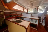 Interior of a 1967 Custom Design #1862 boat, featuring a compact kitchen and wooden cabinetry.