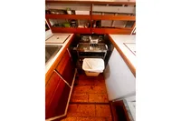 Compact vintage kitchen with wooden cabinets, stove, and sink, Custom Design #1862, 1967.