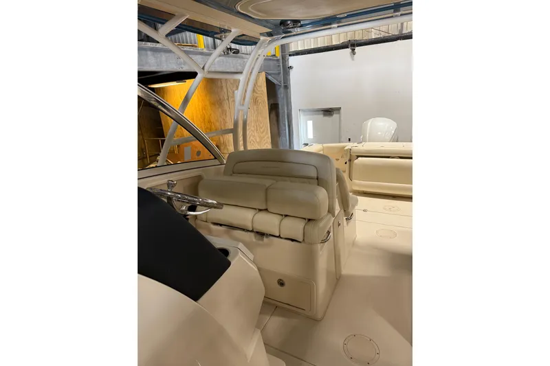  Yacht Photos Pics 2018 Grady-White Freedom 325 boat interior with beige seating and steering wheel.