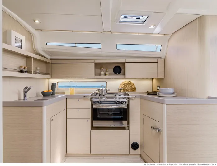  Yacht Photos Pics Modern kitchen interior of 2026 Beneteau 40.1 yacht with sleek cabinetry and appliances.