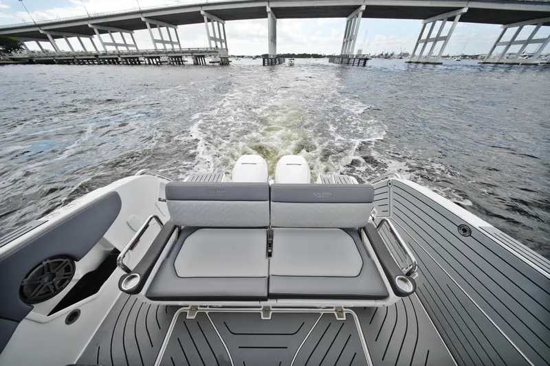  Yacht Photos Pics 2023 Galeon 400 XL boat cruising under a bridge, showcasing sleek seating and design.