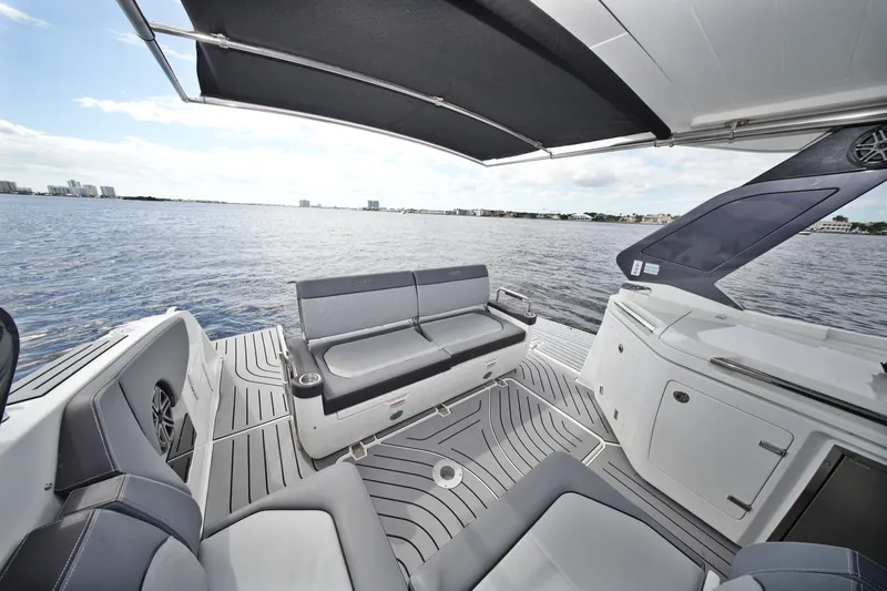  Yacht Photos Pics 2023 Galeon 400 XL yacht deck with seating, overlooking calm waters and city skyline.