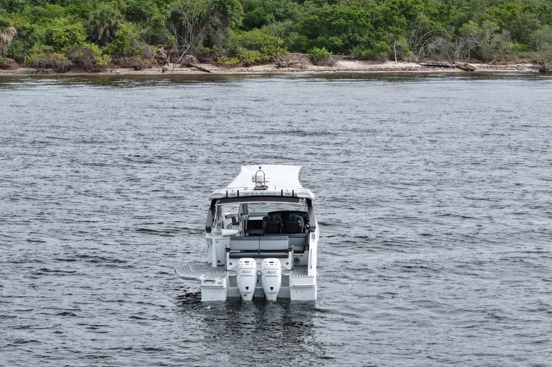  Yacht Photos Pics 2023 Galeon 400 XL yacht on water near lush shoreline.