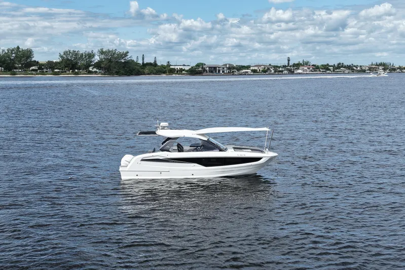  Yacht Photos Pics 2023 Galeon 400 XL yacht on calm waters under a partly cloudy sky.