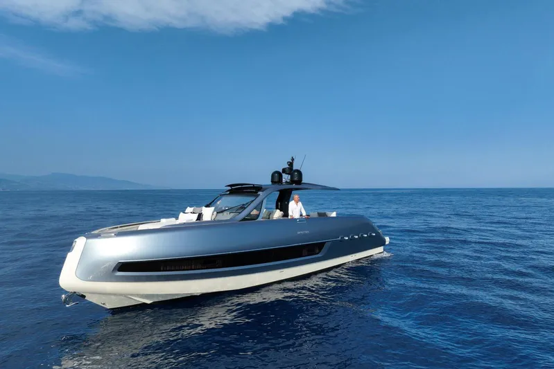  Yacht Photos Pics 2023 Invictus 460TT luxury yacht cruising on open sea under clear blue sky.