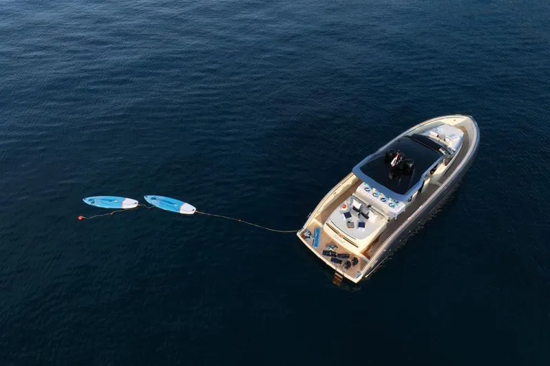  Yacht Photos Pics Aerial view of 2023 Invictus 460TT yacht with paddleboards on calm water.