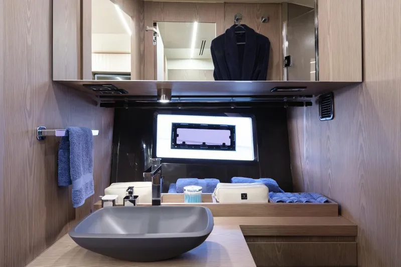  Yacht Photos Pics Luxurious bathroom interior of 2023 Invictus 460TT yacht with modern sink and wooden accents.